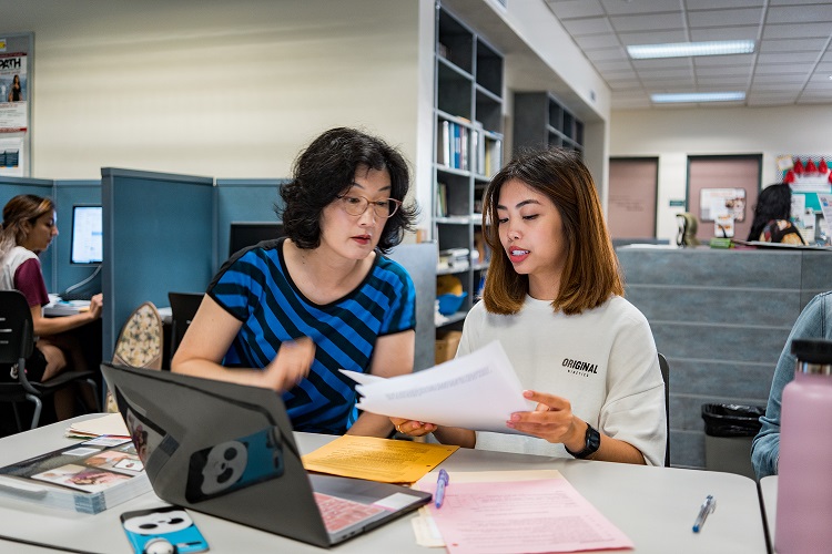 Communication Teacher with Student in the Communication Lab Communication Teacher with Student in the Communication Lab